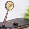 nomon-mini-puntero-t-timeless-table-clock-brass-on-shelf | ikonitaly