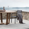 one-black-atmosphera-sunny-patio-chair-with-arms-next-to-sea | ikonitaly